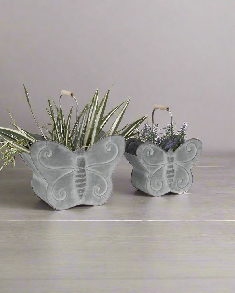 Beautify your home in style with our Nested Butterfly Metal Planter w/Handle - Set of 2. Crafted from zinc for strength & durability, suitable for outdoor as well as indoor use. Features a set of 2 identical but different-sized butterfly planters with hollowed-out space for plants. 
Features:
A beautiful eye-catching statement
Handles to carry the planters
Suitable for indoor as well as outdoor use
Made up of durable material
Colour: Distressed Grey
Material: 100% Zinc
Dimensions: L: 37.5X17X29.5  S: 30.5