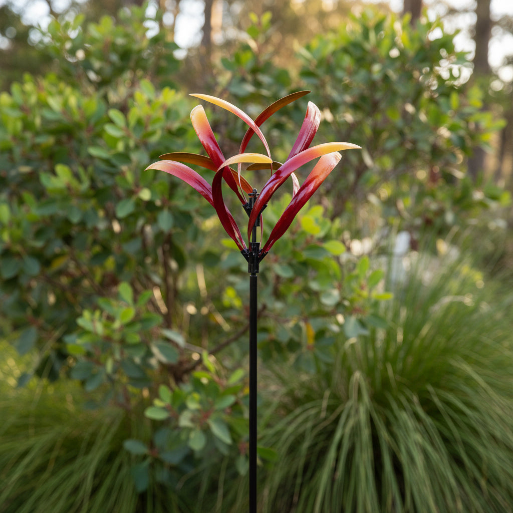 Decorative garden stake with red and yellow leaf-like structures on a white background