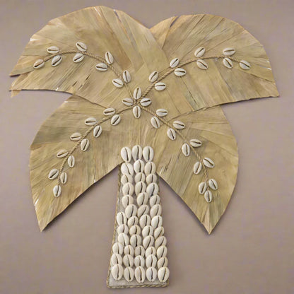 Bring coastal charm into your home with this meticulously crafted Handmade Shell &amp; Weave Palm Tree Wall Art. The artistry behind each detail makes this piece a stunning focal point for any room. A perfect blend of nature-inspired elegance and handmade craftsmanship.

Features:

Delicate seashells &amp; intricately woven leaves
Coastal attraction with handmade artistry
Decorate it in any of the rooms
Colour: White, Natural
Material: Pandan Leaves 50%, Shell 50%
Dimensions: 30x1x30cm